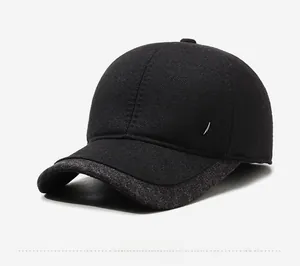 Detail view of winter baseball cap showing thick twill fabric and shield metal emblem