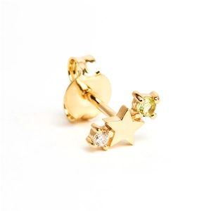 Detail of star-shaped gold stud earring with clear and light green crystals