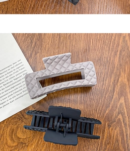 Detail showing matte quilted texture and spring structure of large shark hair clips
