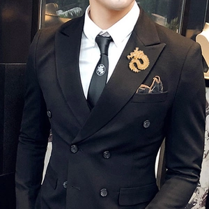 Detailed view of a gold dragon brooch pinned to a premium black men's suit lapel