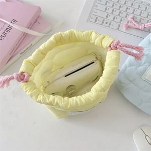 Top view of yellow quilted drawstring storage pouch showing large interior capacity