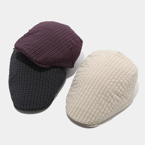 Detailed grid texture of British style flat caps in purple, black and beige colors