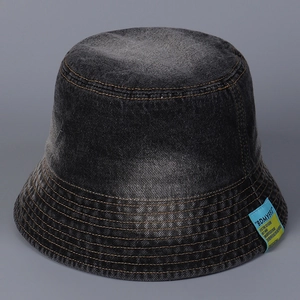Detail of dark denim bucket hat featuring contrast logo patch and orange topstitching