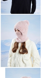 Detail of pink fleece-lined knit winter hat with built-in face mask and fluffy pom pom