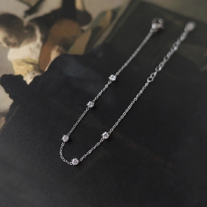 Close-up of a silver titanium steel bracelet featuring five white zircon stones and lobster clasp
