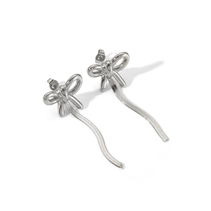 Detail shot of silver bow earrings featuring elegant long snake chain tassels on white background