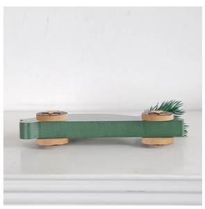 Detailed view of dark green wooden Christmas car with realistic pine needle decor