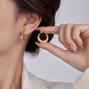 Irregular 18K gold stainless steel hoop earrings shown on a model for a French chic style