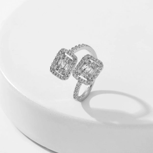 Macro shot of silver open ring featuring dual rectangular cubic zirconia and pave setting