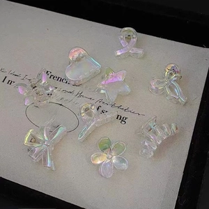 Iridescent mini hair clips in heart and butterfly shapes with a holographic finish
