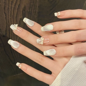 Handmade coffin press-on nails with silver glitter, white French tips, and 3D bows
