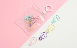 Bulb-shaped candy colored paper clips in a clear PVC storage pouch on a pink background