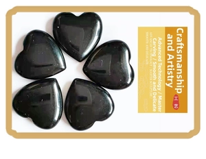 Polished black obsidian heart stones showing smooth finish and master carving detail
