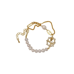 Golden freshwater pearl bracelet with rose diamond pendant on a white background