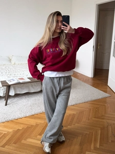 Burgundy crewneck sweatshirt with colorful POSITIVE embroidery and grey joggers
