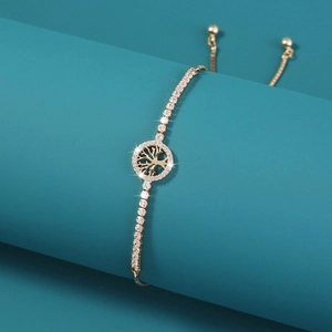 Adjustable golden Tree of Life bracelet with pavé cubic zirconia on green pedestal