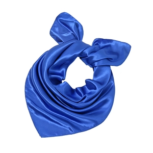 Detail of royal blue satin square scarf showing smooth texture and glossy fabric sheen