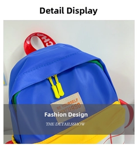 Close-up of kids' canvas backpack with BE YOURSELF leather tag and green zipper detail