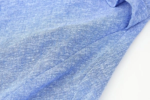 Detailed close-up of blue linen blend fabric texture for summer tiered cami dress