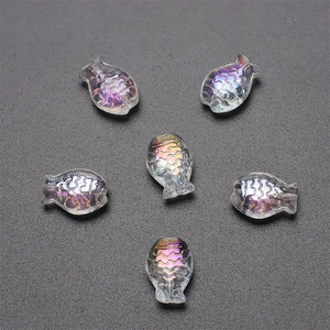 Macro view of six colorful crystal fish pendants with aurora finish for DIY jewelry