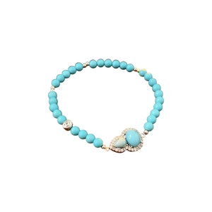 Ethnic style synthetic turquoise gourd beaded bracelet with silver accents on white background