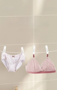Close-up of white minimalist windproof clothespins for drying socks and underwear