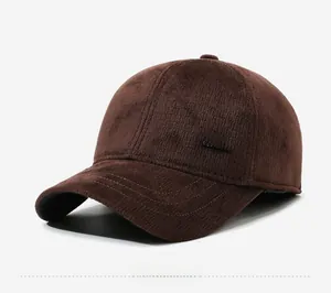 Close-up of brown corduroy baseball cap with velvet texture and silver metal tag