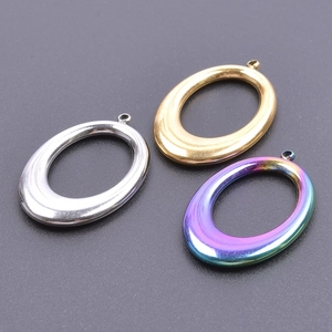 Macro view of oval metal pendant frames in silver, gold and rainbow finish for DIY jewelry