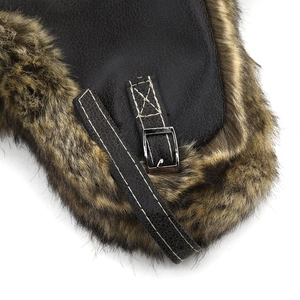 Macro view of textured brown PU leather and thick faux fur lining on a pilot trapper hat