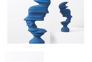 Detail of Klein blue abstract face sculptures with a modern matte finish and wavy texture