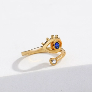 Golden open ring with sapphire evil eye design and white zircon on white platform