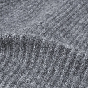 Grey ribbed knit beanie close-up showing soft wool texture and warm thick fabric
