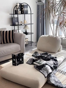 Detailed close-up of beige corduroy chaise lounge with soft square cushion in a modern room