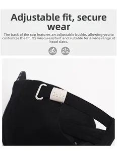 Detail of adjustable silver metal buckle with engraved lettering on black baseball cap