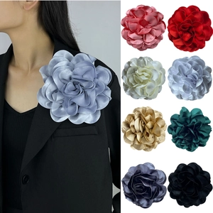Macro detail of 19cm French satin flower brooches in multiple colors for garments