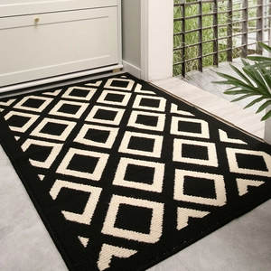 Minimalist geometric entryway doormat with non-slip absorbent material in black and beige