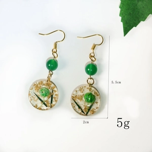 Detail view of handmade lemon flower drop earrings with size markers 5.5cm and 2cm