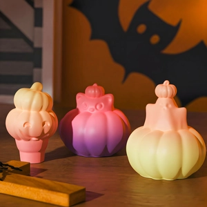 Three-piece Halloween pumpkin ghost figurines with soft gradient colors on wood