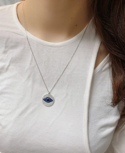 Close-up of S925 sterling silver Evil Eye pendant necklace with blue and white stones