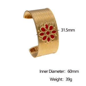 Macro shot of gold-plated bangle showing 31.5mm width and red floral inlay details