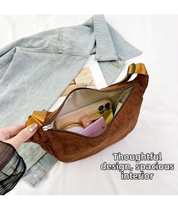 Detail of spacious interior in brown corduroy crossbody bag with daily essentials