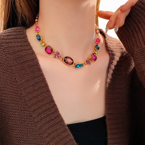 Vintage gold necklace with colorful teardrop gemstones and butterfly diamond accents