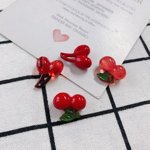 DIY red cherry acrylic resin pendants for jewelry making on white grid cloth fabric