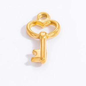Close-up of heart-shaped 18k gold plated key pendant accessory with mirror finish