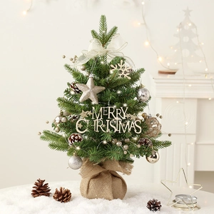 Rotating musical mini Christmas tree with ornaments and rustic burlap base for tabletop