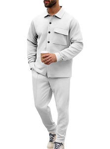Detail of light gray knitted texture on a casual men's long sleeve shirt and trousers set