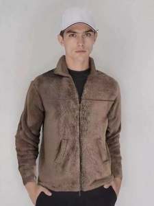 Detail of brown fleece jacket showing high collar and smooth zip closure on fabric