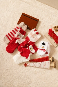 Soft coral fleece Christmas socks featuring Santa and reindeer on a fuzzy rug