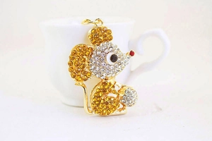 Close-up of golden mouse keychain featuring sparkling amber and clear rhinestones