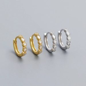 Detail view of gold and silver S925 geometric earrings with marquise-cut marquise crystals